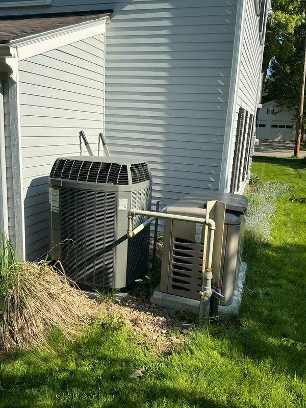 Conducted comprehensive HVAC system evaluation for residential replacement estimate. Assessed existing outdoor equipment configuration including cylindrical air conditioning condenser unit and heat pump system positioned on gravel pads against building exterior. Documented current electrical panel capacity and circuit breaker allocation, noting dedicated circuits for HVAC equipment including furnace, A/C, and crawl space systems. Photographed equipment placement, foundation clearances, and electrical infrastructure to support replacement system specifications and installation planning requirements.