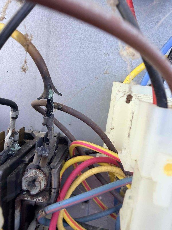 Responded to service call for air conditioning system inspection following reported hail storm damage. Upon arrival, performed comprehensive visual assessment of outdoor condensing unit and associated components. Inspection revealed significant corrosion on refrigerant line connections and valve assemblies, along with weathered electrical wiring and terminal connections showing age-related deterioration. Documented equipment condition with photographs showing rusted mechanical components, discolored wiring harnesses, and corroded pipe fittings. No visible hail damage was identified during inspection; observed issues appear related to normal wear and environmental exposure rather than storm-related impact.