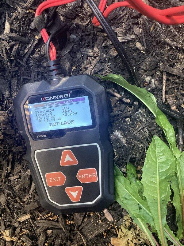 Responded to service call for non-operational Generac generator that was failing to start or transfer power during outage conditions. Performed comprehensive diagnostic testing of the generator's starting battery using electronic battery analyzer, which indicated battery failure and displayed "REPLACE" status. Diagnosed failed battery as root cause preventing generator from initiating startup sequence. Generator system and associated transfer switch equipment located at exterior of residence behind decorative lattice screening.