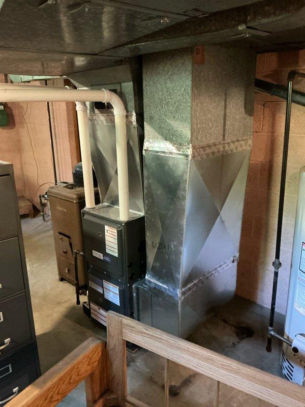 Completed HVAC estimate for air conditioning add-on options to complement existing furnace system that was previously replaced in 2023. Evaluated basement mechanical room setup, including existing ductwork configuration with tapered plenum system and electrical panel capacity for potential AC installation.
