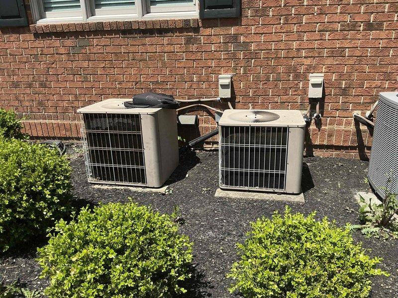Conducted site assessment at rental property with multiple HVAC systems to provide replacement estimate options. Evaluated non-functional air conditioning system serving master bedroom area, documenting existing equipment configuration including three outdoor condensing units and indoor air handler with Ultra 96 furnace. Presented full system replacement options to property owner, photographed current installation showing refrigerant line routing, electrical connections, and ductwork layout to support equipment sizing and replacement specifications.