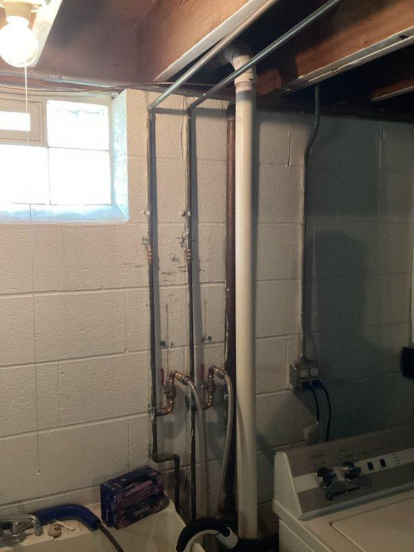 Completed installation of two valves in the slop sink and replaced shower head and handle assembly in the bathtub using customer-supplied hardware. All fixtures tested and verified for proper operation with no leaks detected.