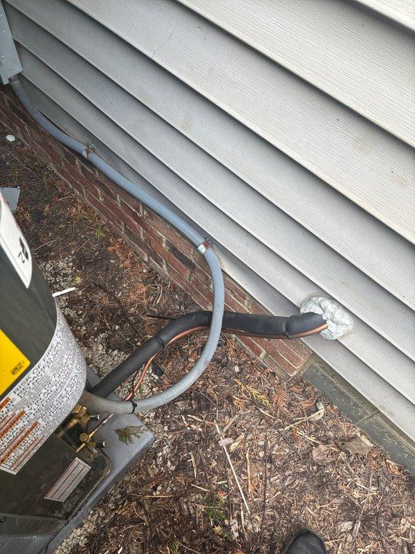 Completed full HVAC system installation including 96% efficiency furnace, air conditioning unit, and humidifier. Installed new outdoor condensing unit with insulated refrigerant line set routed along building exterior, connected indoor equipment, and commissioned entire system for optimal performance.
