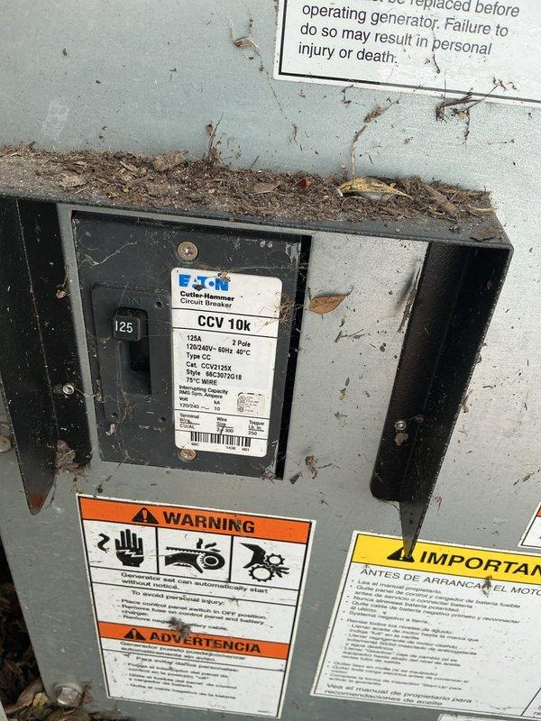 Responded to service call for Generac backup generator that failed to activate during neighborhood power outage. Upon arrival, performed visual inspection of unit and control panel, noting accumulation of debris and environmental contamination on exterior surfaces and electrical compartment. Inspected Eaton Cutler-Hammer Power Defense circuit breaker panel (125A rating) and internal generator control interface with maintenance schedule display. Documented current condition of unit showing weathering, dirt buildup, and operational status indicators. Unable to locate illuminated status light as reported by customer, suggesting potential control panel malfunction or power supply issue to monitoring system.