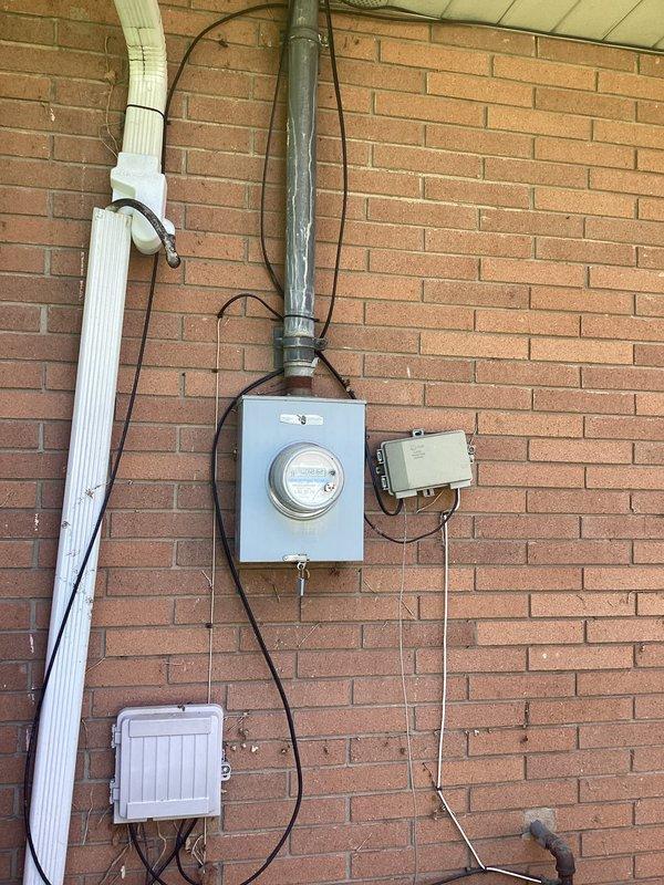 Conducted site assessment for backup generator installation. Evaluated existing electrical service entrance system, including meter base, service panel, and conduit routing on exterior brick wall. Inspected basement infrastructure and available mounting locations for transfer switch installation. Documented current electrical configuration and photographed service equipment to prepare comprehensive generator installation estimate.