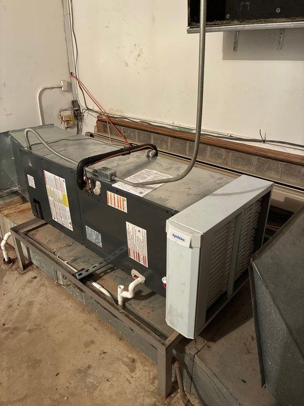 Completed full HVAC system installation including new air handler and outdoor condensing unit. Installed dual-unit configuration in mechanical room on elevated wooden platform with proper leveling and support. Air handler mounted alongside existing equipment with new copper refrigerant line set running to exterior condenser, properly insulated with red and black sleeves. Verified and installed 25-amp Littelfuse FLNR fuses in outdoor unit disconnect. All electrical connections completed per manufacturer specifications, refrigerant lines brazed and pressure tested, and system commissioned with successful startup.