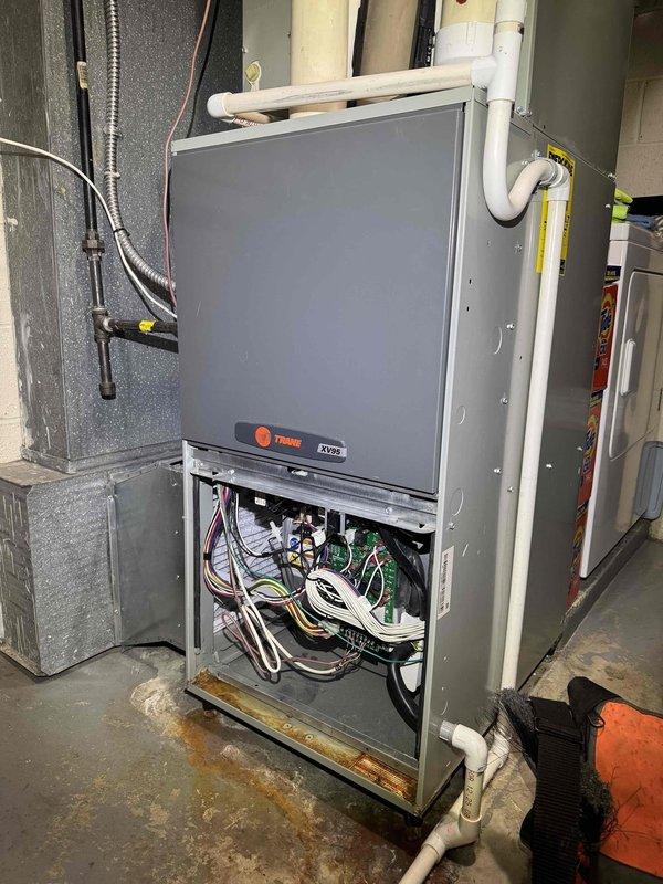 Responded to no cooling complaint on central air conditioning system. Upon arrival, confirmed outdoor condensing unit operating but indoor air handler not delivering cool air. Inspected Trane air handler unit manufactured in 2011, removed access panel and performed diagnostic testing of internal components including circuit board, wiring connections, and mechanical assemblies. Identified system malfunction preventing proper cooling operation. Evaluated refrigerant lines, electrical connections, and control systems to determine root cause of cooling failure. Documented equipment condition with photographs showing internal components and manufacturer specifications for 2-ton capacity unit.
