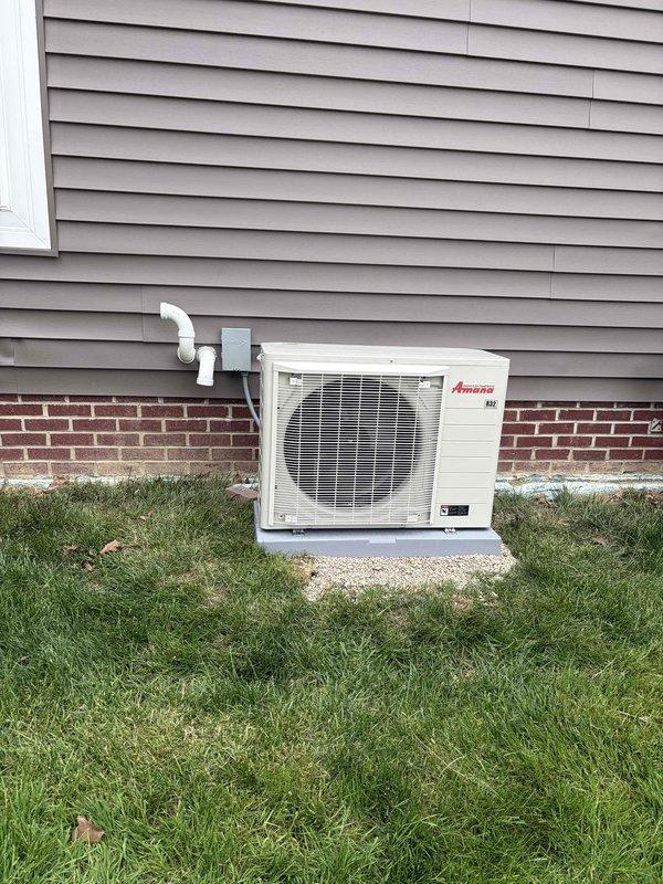 Completed full HVAC system installation including 80% efficiency furnace, air conditioning unit, and humidifier from the S Series product line. Installed Amana condenser unit on exterior concrete pad with proper refrigerant line connections and electrical disconnect. Verified system operation with temperature readings showing 58.2°F at evaporator coil, confirming proper cooling performance and adequate condensation formation. All equipment mounted securely with drainage lines properly routed through exterior wall.