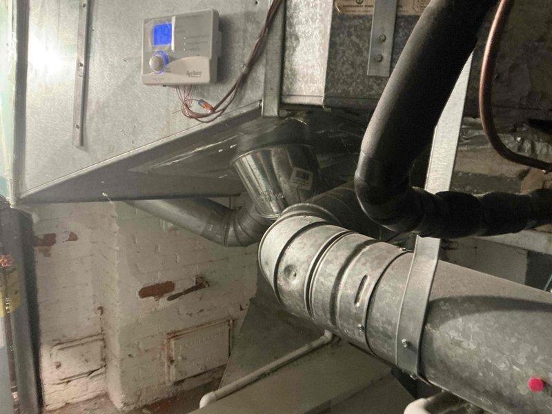 Completed full system replacement estimate for residential HVAC system. Assessed existing air handler installation showing signs of age with rust staining and discoloration, evaluated ductwork configuration including flexible and rigid galvanized metal ducts with Y-junction connections, and inspected basement mechanical room setup with existing thermostat control. Provided three-tier equipment options ranging from 13.4-16 SEER air conditioning units paired with 80-96% AFUE gas furnaces, all Goodman brand systems designed to replace aging equipment and improve energy efficiency.