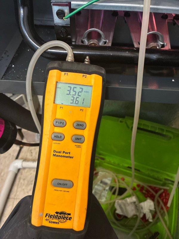 Completed installation of 80% efficiency Amana furnace with liner and water heater replacement in residential mechanical room. Relocated refrigerant lineset by pumping AC system into itself to safely maneuver existing equipment and facilitate new water heater installation in confined space. Verified system operation with manometer readings showing balanced static pressures of 361-362, confirming proper airflow and equipment function. All equipment operational and installation complete per manufacturer specifications.