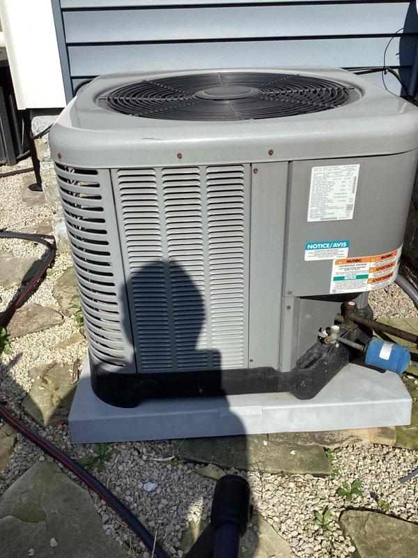 Completed comprehensive cooling system tune-up on residential HVAC unit. Performed standard maintenance procedures including temperature diagnostics at supply register (recorded 48.5°F discharge temperature), inspected outdoor condenser unit condition and airflow, verified refrigerant line connections, and assessed overall system operation. Unit operating within normal parameters; noted age-related cosmetic wear on interior grille component with rust staining present but not affecting system performance.