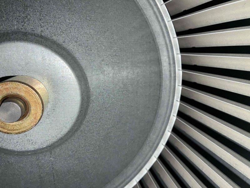 Completed routine cooling system maintenance inspection on residential HVAC unit. Examined blower wheel assembly and verified proper condition of squirrel cage fan blades, confirming adequate airflow capacity and structural integrity. Inspected electrical connections at motor terminal assembly, noting age-related wear and minor corrosion on junction terminals and wiring connections that will require monitoring during future service visits.