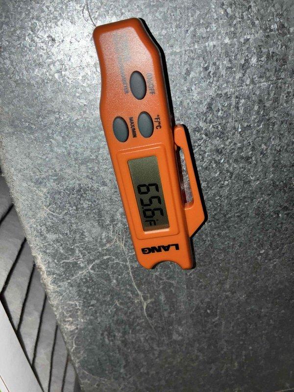 Completed preventative maintenance visit on cooling system. Performed temperature diagnostics using digital thermometer, recording supply air temperature of 55°F. Inspected condenser fan assembly and blower components through protective grille, noting dust accumulation on fan housing and filter media that will require monitoring during next service interval.