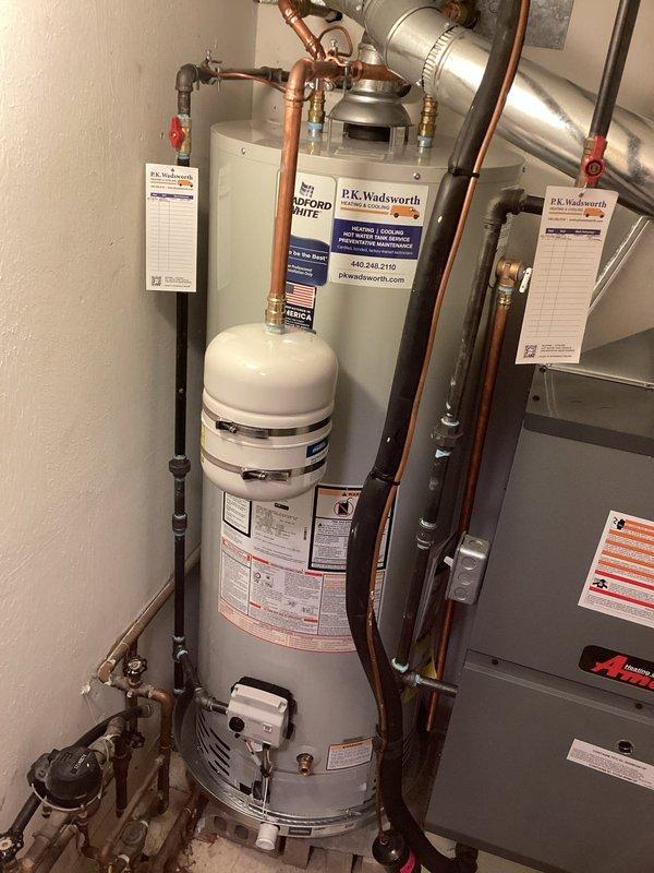 Responded to no hot water complaint on recently installed tanked water heater. Upon arrival, performed diagnostic inspection of new installation including all connections, valves, and control settings. Verified proper gas supply, water supply connections, and venting configuration. Inspected expansion tank mounting and pressure relief valve installation. Checked thermostat settings and pilot light operation. Adjusted temperature control dial to appropriate setting and confirmed ignition sequence. Tested hot water delivery at fixtures to verify system functionality. Ensured all copper piping connections were secure and leak-free. Confirmed proper clearances and code compliance for installation. System restored to full operational status with adequate hot water production throughout residence.