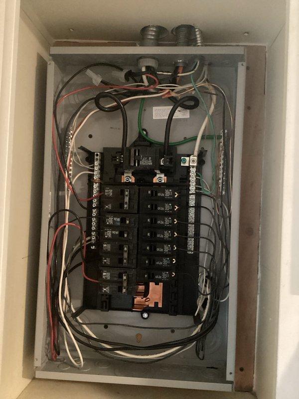 Completed comprehensive whole home electrical inspection. Documented main electrical panel configuration, noting circuit breaker arrangement, conductor routing, and overall panel condition. Inspected kitchen area electrical outlets and verified proper receptacle function with multiple devices in use. Captured photographic documentation of all findings for homeowner records.