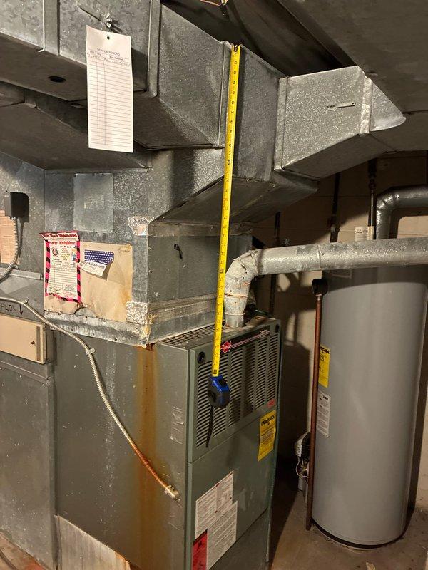 Conducted on-site assessment of existing HVAC system in residential basement mechanical room to provide equipment replacement options. Evaluated current furnace unit, ductwork configuration, and overall system layout. Documented existing equipment conditions and spatial measurements to determine appropriate replacement specifications and installation requirements.