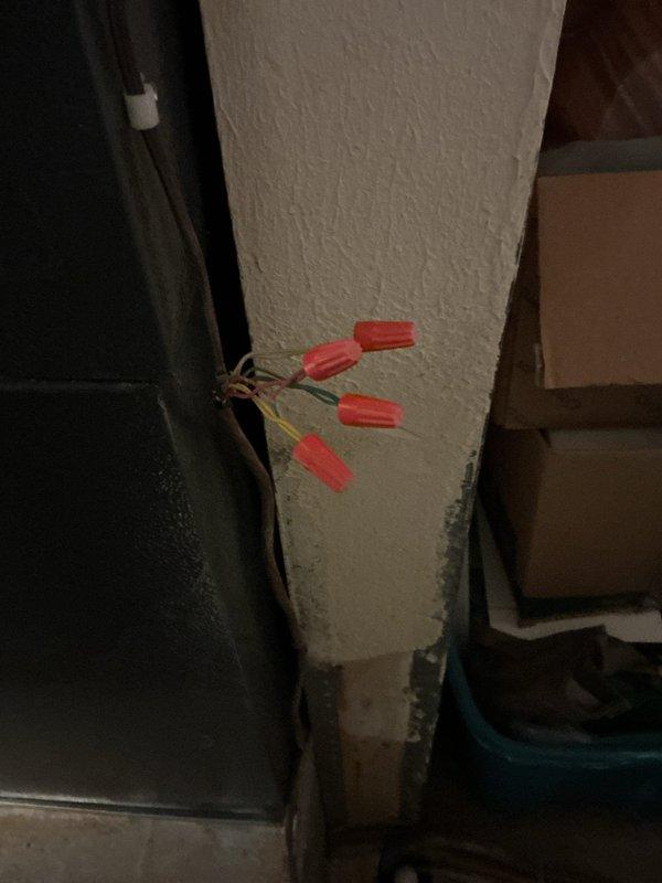 Responded to no cooling call on Amana HVAC system. Upon arrival, found unit would not power on. Inspected electrical connections at furnace and air handler, identified loose wire connections with exposed conductors secured by wire nuts in utility area. Tightened and properly secured all electrical connections, verified proper voltage supply to system. Cycled unit through startup sequence, confirmed system operational and cooling properly. Installed locking refrigerant caps on outdoor condenser unit per code inspector requirements.