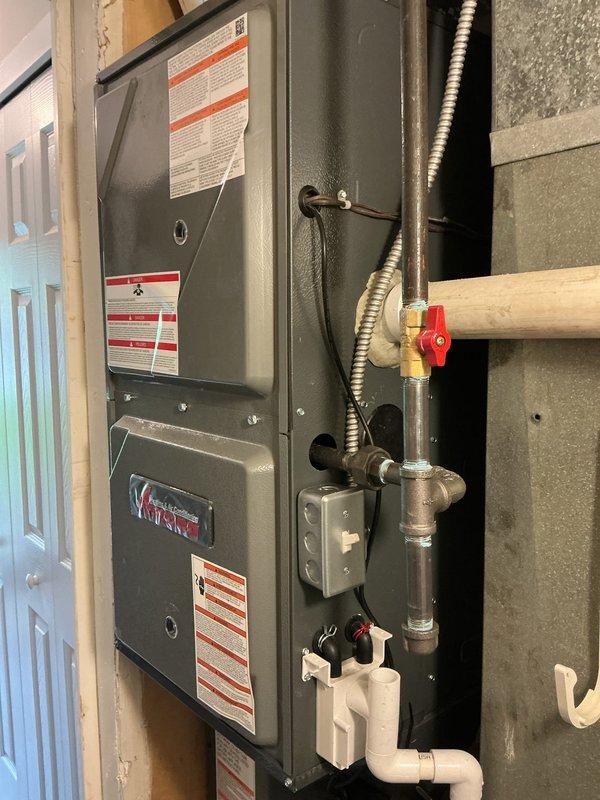 Responded to no cooling call on Amana HVAC system. Upon arrival, found unit would not power on. Inspected electrical connections at furnace and air handler, identified loose wire connections with exposed conductors secured by wire nuts in utility area. Tightened and properly secured all electrical connections, verified proper voltage supply to system. Cycled unit through startup sequence, confirmed system operational and cooling properly. Installed locking refrigerant caps on outdoor condenser unit per code inspector requirements.