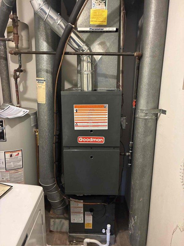 Completed full HVAC system installation including 80% efficiency Goodman furnace and air conditioning unit in residential utility space. Installed main furnace unit with complete ductwork system, featuring insulated metal supply and return ducts branching from the top of the unit. Ran and connected copper refrigerant lines between indoor and outdoor components, properly insulated and secured throughout the installation. Installed gas supply line with shutoff valve featuring red handle for easy identification and emergency access. Completed all electrical connections including dedicated junction box and proper wiring to code. Tested system operation to verify proper heating and cooling functionality, airflow, and refrigerant charge levels.