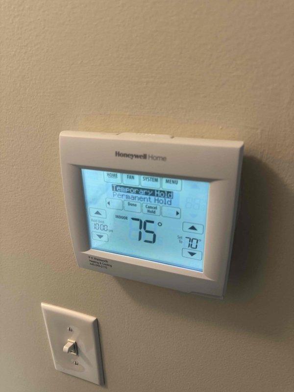 Completed full HVAC system installation including 96% efficiency furnace and air conditioning unit. Installed outdoor condensing unit on gravel pad with proper refrigerant line connections, mounted electrical disconnect box, charged system to manufacturer specifications as verified with manifold gauges, and programmed new Honeywell Home thermostat with temporary and permanent hold functions. System tested and operating within normal parameters.