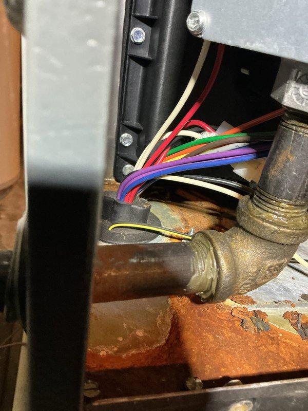 Responded to no cooling call and performed system diagnostics. Upon inspection, discovered significant corrosion and oxidation on gas valve assembly and surrounding components, indicating moisture intrusion and potential safety concerns. Documented conditions with photographic evidence showing deteriorated brass fittings, rust deposits on base pan, and compromised electrical connections that required immediate attention to restore safe system operation.