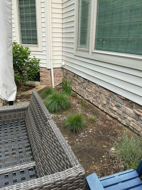Conducted on-site evaluation for mini split installation options in residential bedroom currently utilizing portable air conditioning unit. Assessed interior wall placement possibilities and exterior mounting locations, photographed proposed installation areas including interior bedroom space and exterior wall with existing siding and foundation access for condensing unit placement.