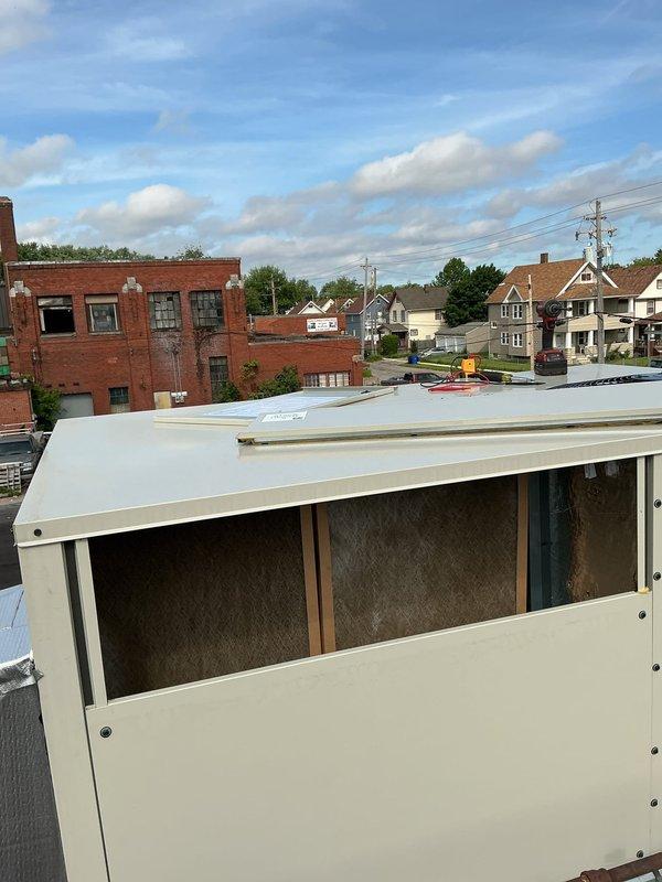 Responded to no cooling complaint on rooftop package unit. Upon arrival, found unit installed on elevated wooden platform with copper refrigerant lines visible. Performed diagnostic evaluation of system to determine cause of cooling failure and documented equipment condition with photographs for service records.