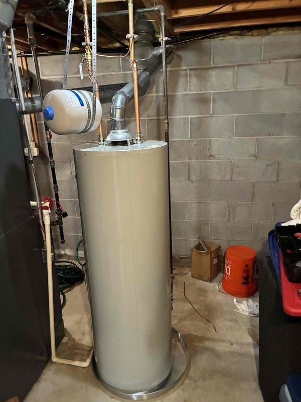 Returned to property to complete installation of 50-gallon residential water heater with required code upgrades. Successfully installed new unit in basement mechanical room with proper copper piping connections, expansion tank mounting, and metallic exhaust venting system. All plumbing connections, gas lines, and safety components were installed to current code specifications and tested for proper operation.