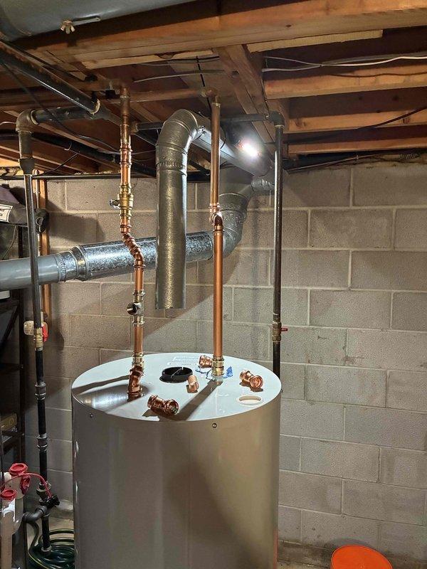 Returned to property to complete installation of 50-gallon residential water heater with required code upgrades. Successfully installed new unit in basement mechanical room with proper copper piping connections, expansion tank mounting, and metallic exhaust venting system. All plumbing connections, gas lines, and safety components were installed to current code specifications and tested for proper operation.