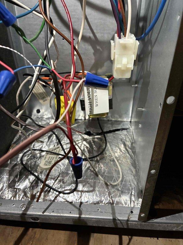 Responded to no cooling call on residential air conditioning system. Upon arrival, customer reported unit not coming on with no cool air being produced. Performed diagnostic inspection of HVAC equipment located in crawlspace area. Examined ProSelect condensate pump assembly and electrical connections, noting accumulated dirt and grime on unit housing. Inspected control panel wiring and internal components, checking all electrical connections including wire nuts and low voltage wiring bundle. Verified proper connections on white plastic terminal block and examined condition of foil-lined control housing. Addressed service issue and restored system to proper operating condition.