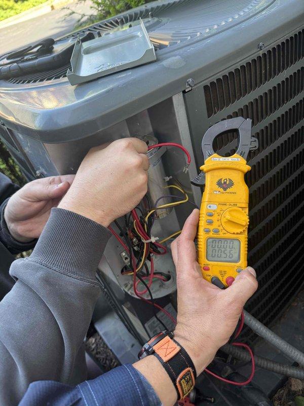 Responded to no cooling complaint on residential air conditioning system. Performed electrical diagnostics on outdoor condensing unit using digital clamp meter and test leads to measure voltage and current readings. Unit evaluated and serviced to restore proper cooling operation.