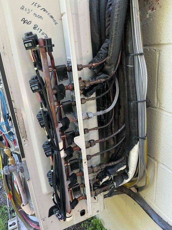 Responded to service call for one or two Fujitsu mini-split systems reported as not working properly. Upon arrival, performed visual inspection and diagnostic evaluation of outdoor condenser unit. Opened service panel to access internal components including refrigerant lines, electrical controls, and circuit boards. Verified system operates on R-410A refrigerant as indicated on unit specifications. Inspected copper refrigerant lines, electrical connections, and control wiring for visible damage or loose connections. Documented equipment condition and configuration through photographic records for service history. Completed system assessment and provided recommendations for proper operation.
