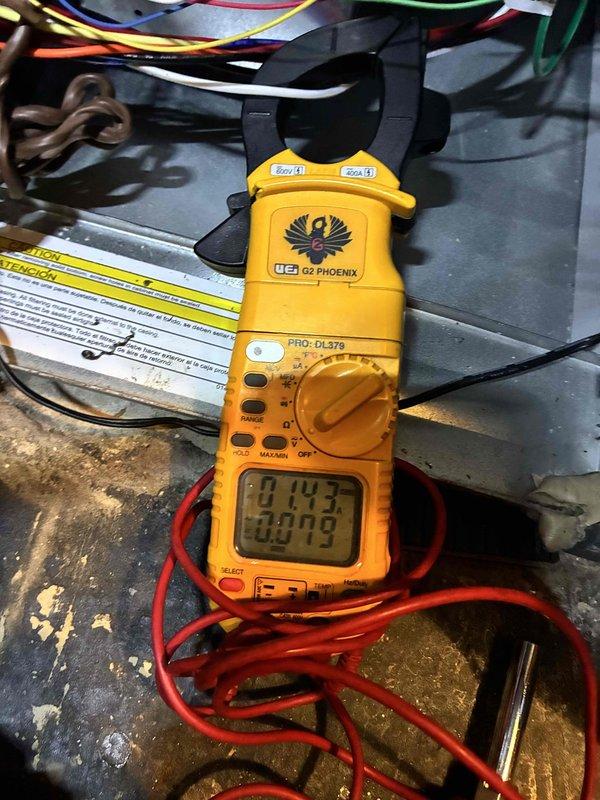 Completed comprehensive cooling system tune-up on residential HVAC unit. Performed electrical diagnostics using digital multimeter to verify proper voltage and amperage readings across system components. Inspected and confirmed pleated air filter condition within attic-mounted air handler, noting proper installation and adequate filtration media for continued system efficiency.