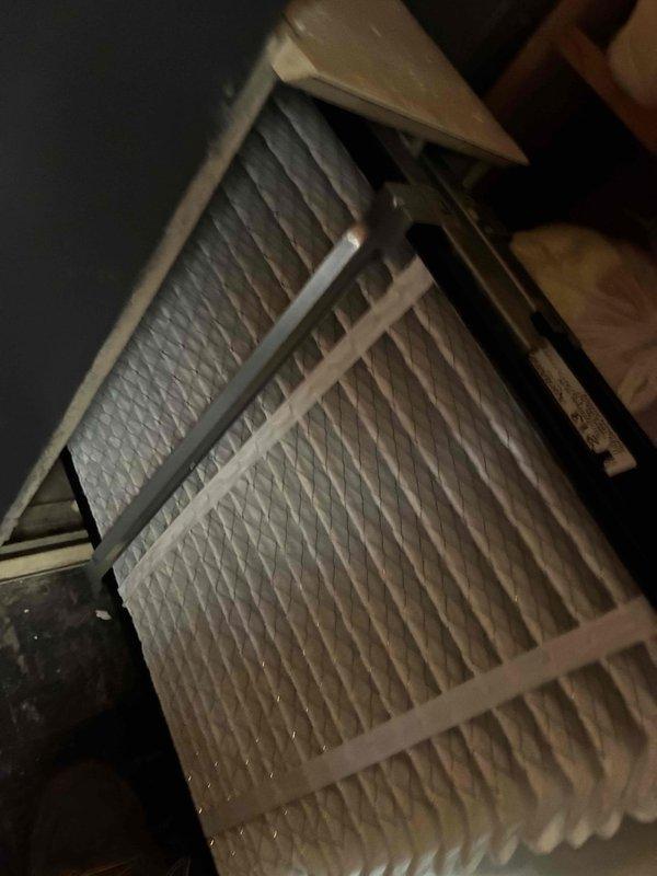 Completed comprehensive cooling system tune-up on residential HVAC unit. Performed electrical diagnostics using digital multimeter to verify proper voltage and amperage readings across system components. Inspected and confirmed pleated air filter condition within attic-mounted air handler, noting proper installation and adequate filtration media for continued system efficiency.