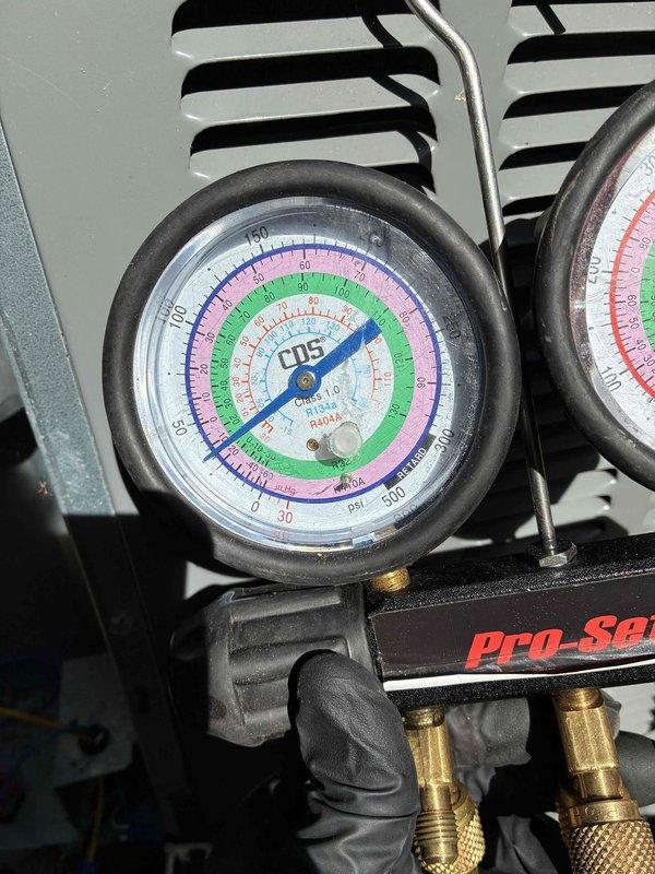 Responded to no cooling complaint. Connected manifold gauge set to measure system pressures and diagnose air conditioning unit. Performed refrigerant pressure analysis to determine system operating conditions and identify cause of failure.