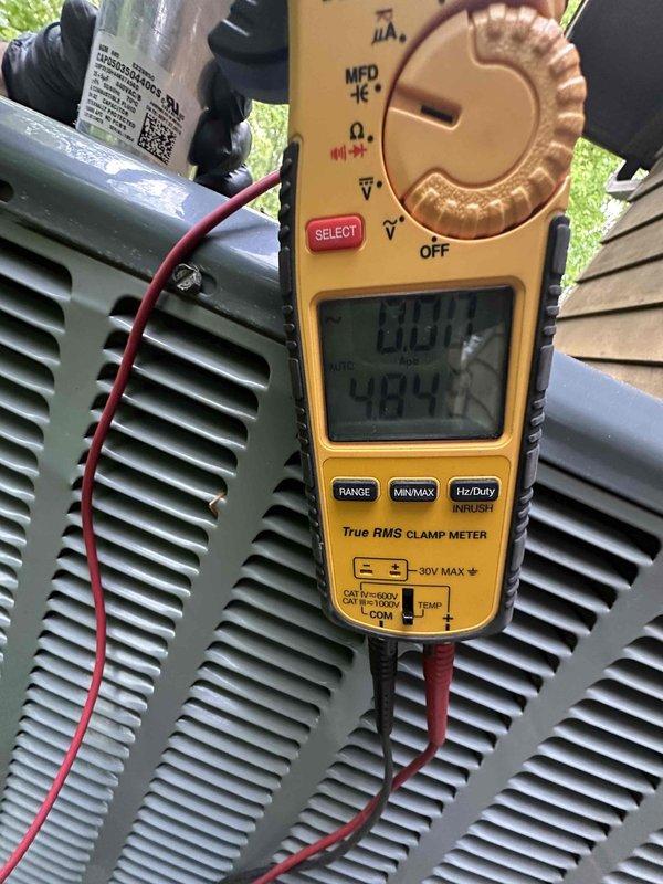 Performed routine cooling system maintenance on outdoor condensing unit. Used digital clamp meter to verify proper amperage draw and voltage readings on compressor and electrical components, confirming system is operating within manufacturer specifications. All measurements indicated normal operating conditions with no issues detected.