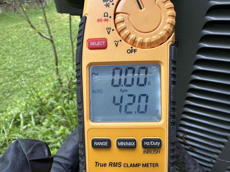 Performed routine cooling system maintenance on outdoor condensing unit. Used digital clamp meter to verify proper amperage draw and voltage readings on compressor and electrical components, confirming system is operating within manufacturer specifications. All measurements indicated normal operating conditions with no issues detected.