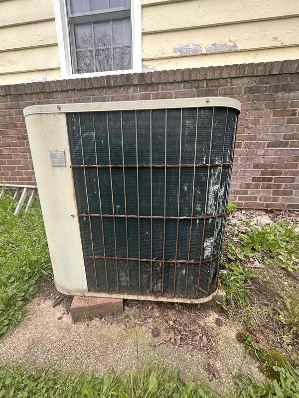 Conducted hail damage assessment on residential outdoor condensing unit. Unit exhibited significant exterior deterioration including weathered casing, corroded refrigerant lines, and damaged condenser grille with visible impact marks. Documented damage with photographs and provided repair estimate for insurance claim purposes.