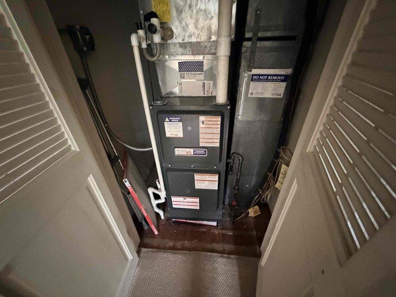 Responded to no cooling complaint on residential split system air conditioning unit. Upon arrival, performed visual inspection of outdoor condenser unit and indoor air handler/furnace system. Condenser unit appeared in good physical condition with intact housing and protective grille. Verified refrigerant line set connections at exterior unit showed no obvious signs of damage or refrigerant leakage. Indoor equipment located in utility closet with adequate clearance and access. Documented system configuration with photographs for service records. Confirmed best contact information with customer for follow-up communication regarding diagnostic findings and repair recommendations.
