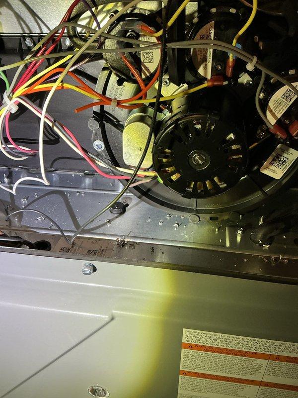 Responded to emergency no-cooling call on recently installed central air conditioning system at residential property. Upon inspection, identified recall-related issue affecting newly installed equipment. Examined blower motor assembly, electrical connections, and capacitor configuration within air handler cabinet. Verified proper wiring connections across multi-speed blower motor terminals and inspected all wire routing including control wiring. Addressed recall component concern and restored system to proper cooling operation.