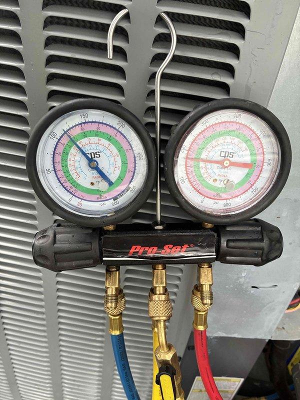 Responded to no cooling complaint and performed diagnostic testing on residential air conditioning system. Connected manifold gauge set to measure refrigerant pressures and assess system performance. System evaluation completed with pressure readings documented for proper cooling operation.