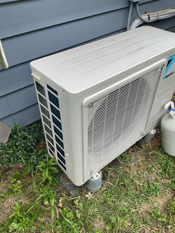 Responded to no cooling call for central AC system and mini-split unit. Inspected Daikin RX24AXVJU outdoor condenser unit and confirmed operational status of equipment. One of two mini-split systems reported power button flashing without unit activation, requiring diagnostic evaluation of indoor head unit and electrical components.