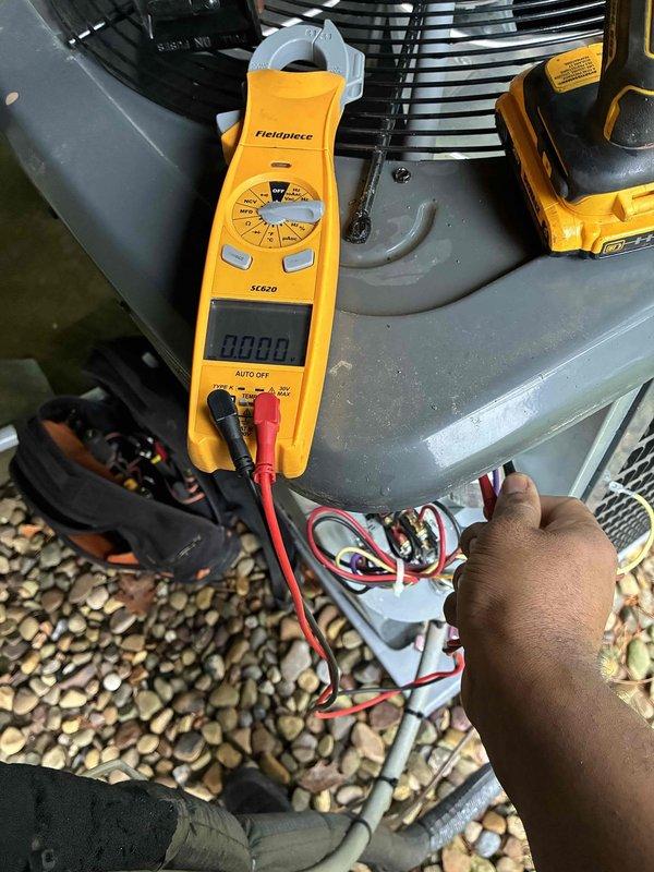 Completed comprehensive cooling maintenance on HVAC system. Performed electrical diagnostics using clamp meter to verify proper amperage and voltage at condensing unit, tested system parameters in mechanical space with digital meter recording temperature reading of 93.9°F. All components inspected and system operating within normal specifications.