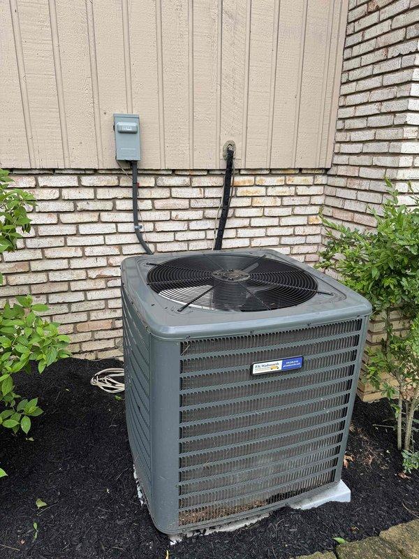 Performed routine cooling system maintenance on residential outdoor condensing unit. Conducted operational testing and electrical measurements using digital clamp meter to verify proper amperage draw and system performance. Unit operating within normal parameters with fan motor functioning correctly and adequate airflow through condenser coils.