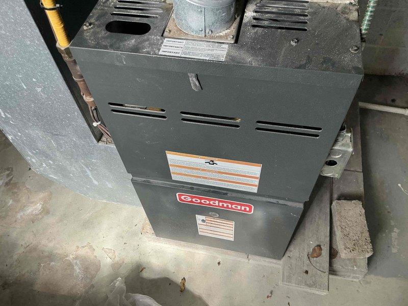 Conducted estimate for complete HVAC system replacement at residential property with non-functioning air conditioning unit. Assessed existing Goodman brand forced air furnace and cooling system installed in basement utility area, documenting current equipment condition including furnace cabinet, ductwork connections, refrigerant lines, and associated components. Provided homeowner with replacement options and recommendations for new heating and cooling system installation.