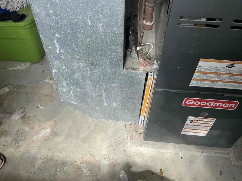Conducted estimate for complete HVAC system replacement at residential property with non-functioning air conditioning unit. Assessed existing Goodman brand forced air furnace and cooling system installed in basement utility area, documenting current equipment condition including furnace cabinet, ductwork connections, refrigerant lines, and associated components. Provided homeowner with replacement options and recommendations for new heating and cooling system installation.