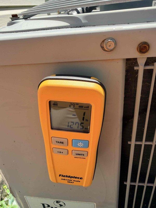 Responded to complaint of inadequate cooling in MG room for 15-year-old Payne air conditioning system. Performed diagnostic evaluation of outdoor condensing unit using digital HVAC measurement tools and Fieldpiece Job Link Scale to assess system performance and refrigerant charge. Conducted thorough inspection of unit components, including compressor operation, condenser coil condition, and electrical connections. System showed signs of age-related wear consistent with 15 years of service. Measured and documented system pressures and temperatures to determine proper refrigerant levels and overall system efficiency. Evaluated cooling capacity and airflow characteristics to identify potential causes of reduced performance in affected room.