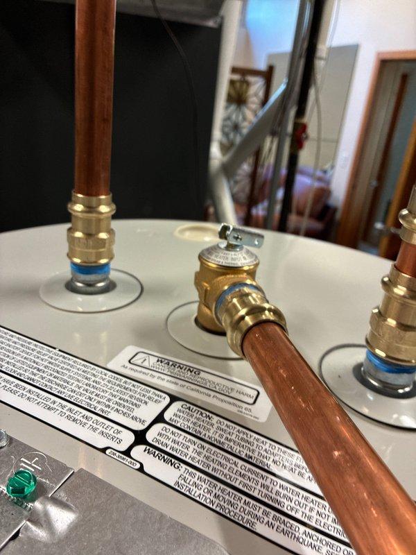 Completed installation of 55-gallon residential water heater with full plumbing connections, including copper supply lines, brass shut-off valves, and expansion tank integration. All connections were properly fitted and tested, with the unit operational and meeting manufacturer specifications upon completion.