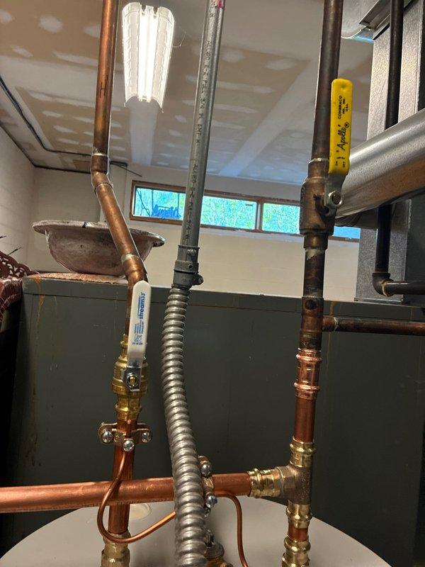 Completed installation of 55-gallon residential water heater with full plumbing connections, including copper supply lines, brass shut-off valves, and expansion tank integration. All connections were properly fitted and tested, with the unit operational and meeting manufacturer specifications upon completion.