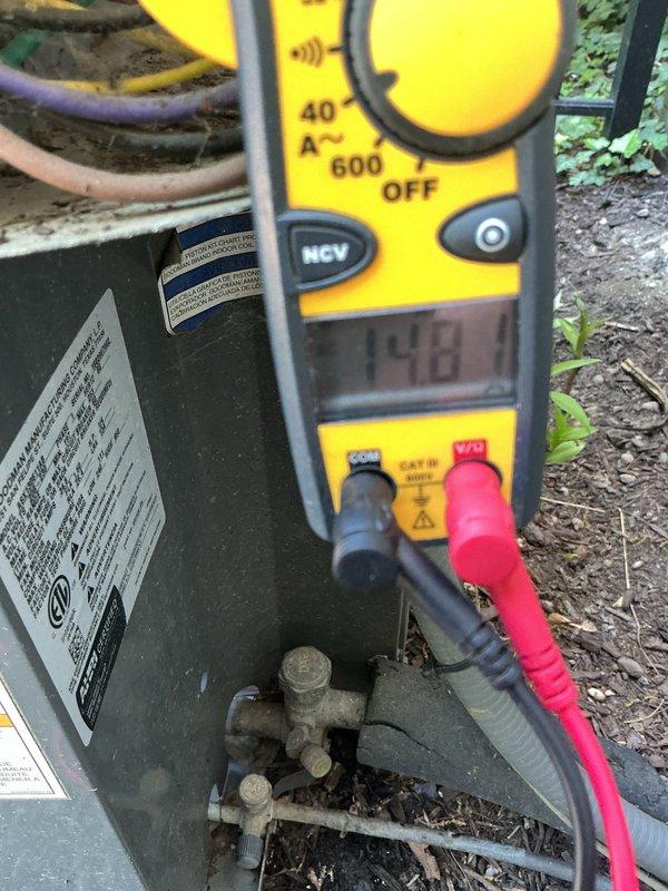 Performed comprehensive cooling maintenance on outdoor HVAC unit, including electrical diagnostics with multimeter readings showing 138.1 amperage, capacitor inspection with verification of all wire connections (brown, red, purple, and yellow leads), and visual assessment of equipment condition. All components found operating within normal parameters; unit returned to service.